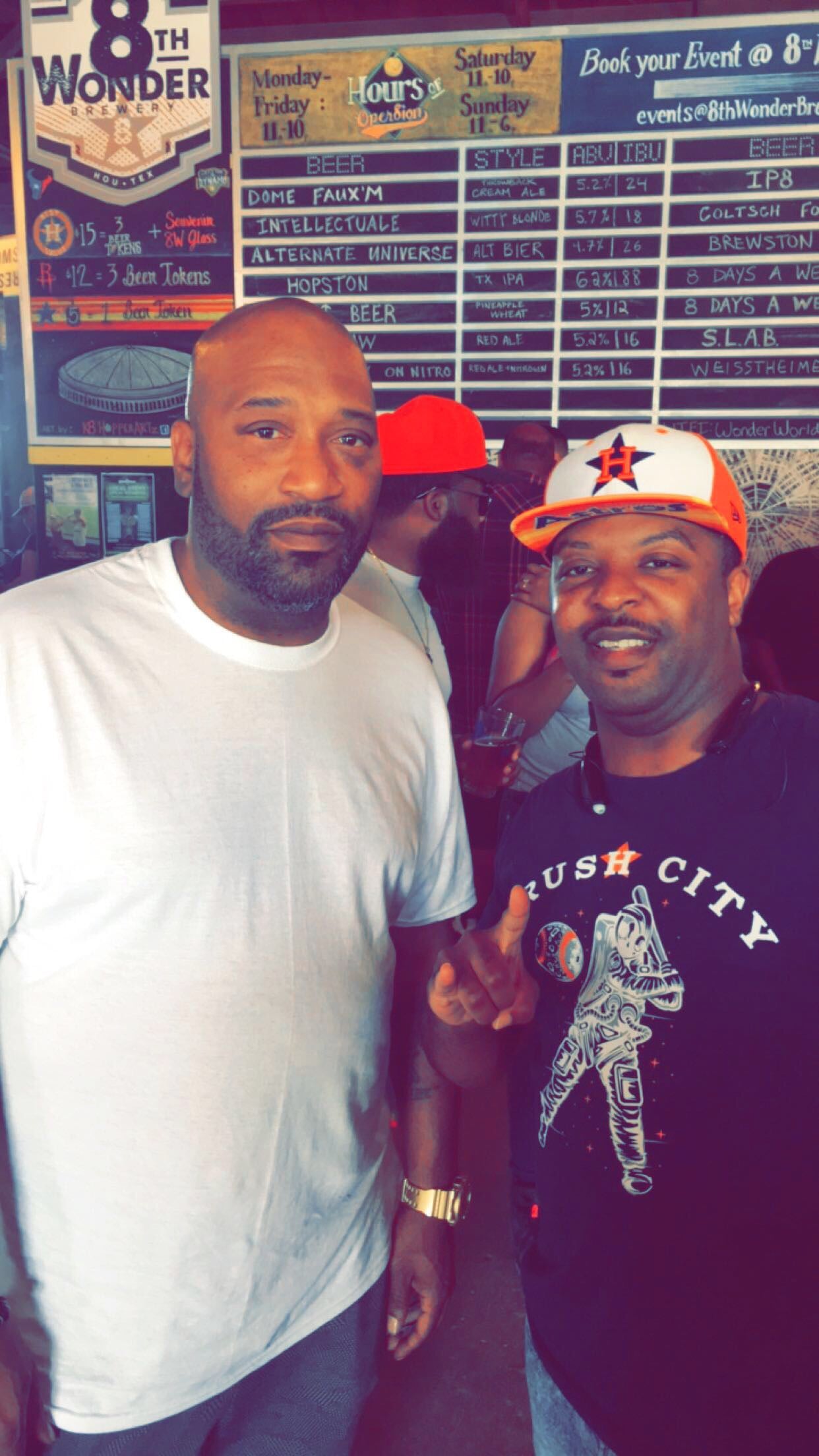 Houston rapper, Bun B, takes a picture with Diverscity clothing co owner, Adonis Alexander, wearing the HTX baseball tee.
